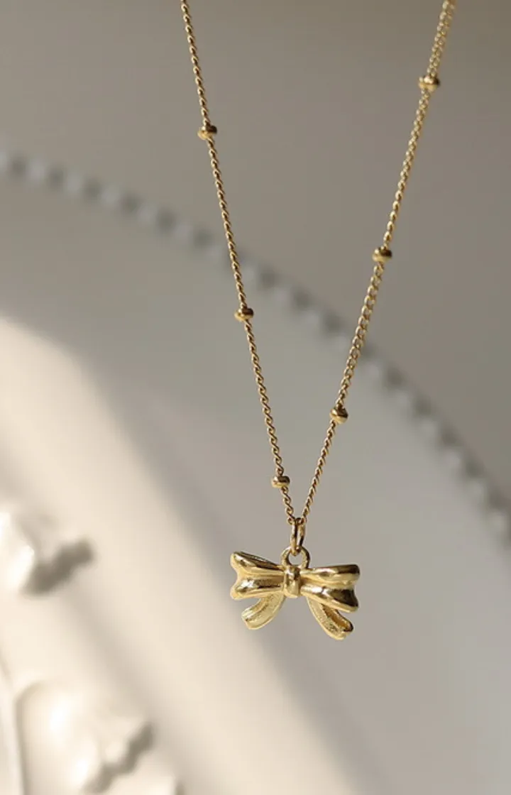 Ruby Elegance Ribbon Pendant Necklace in Gold